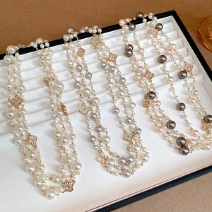 Elegante collana di perle a più fili con ciondoli a fiore in strass