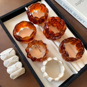 Assorted vintage tortoiseshell resin elastic bracelets in amber and ivory finishes