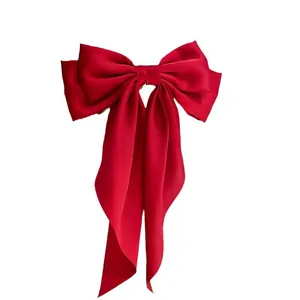 Elegant large red satin bow hair clip featuring long flowing ribbons for hair style