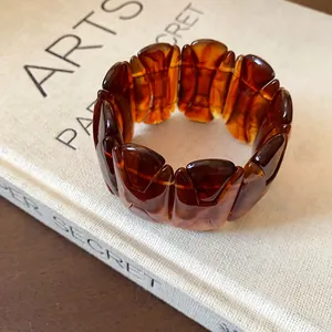 Detailed macro view of a retro amber-colored stretch bracelet with tortoise shell texture