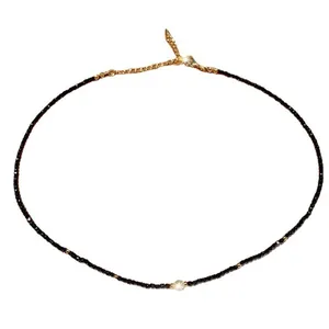 Elegant black crystal beaded necklace with central pearl and gold clasp for women