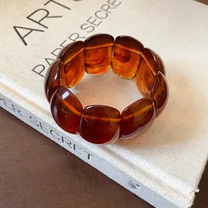 Close-up detail of a vintage amber marbled oval segment elastic stretch bracelet