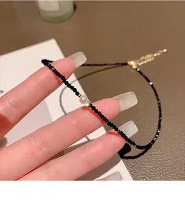 Elegant minimalist black crystal beaded choker necklace with a central pearl detail