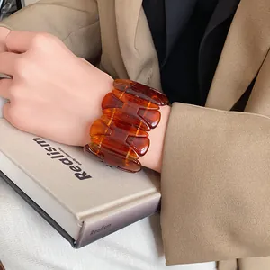 Close-up detail of a vintage marbled amber elastic bracelet for women's jewelry.