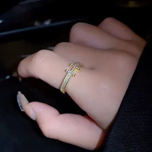 Detailed close-up of a gold-plated H-letter open ring with micro-set sparkling zircons