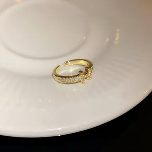 Exquisite detail of gold plated H letter open ring with shimmering pavé zircon setting