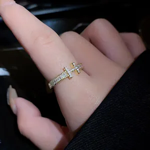 Macro detail of gold plated H letter ring featuring sparkling cubic zirconia stones