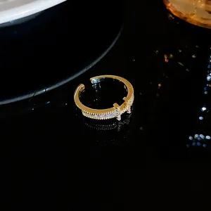 Close-up of gold-plated H letter open ring featuring micro-pave zircon details