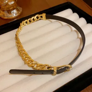 Detailed view of an elegant gold cuban chain and black leather spliced buckle choker necklace