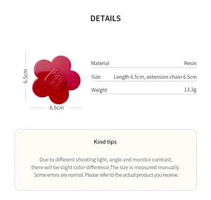 Detailed view of red resin flower hair clip with size and material specifications