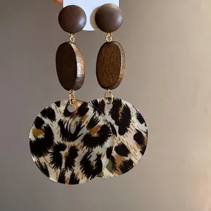 Minimalist leopard print circular dangle earrings with wooden beads and silver pins