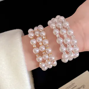Elegant three-layer pearl bracelet with rhinestones in French vintage style on wrist