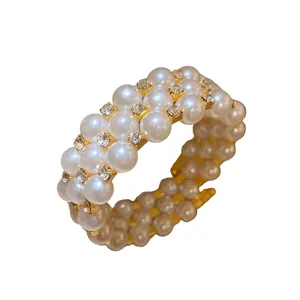 Elegant vintage French three-layer pearl bracelet featuring rhinestones and gold-tone finish