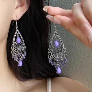 Bohemian teardrop tassel earrings with purple stones and intricate silver patterns