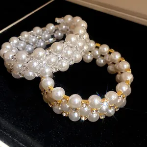 Macro view of three-layer pearl bracelets with rhinestones in gold and silver finish
