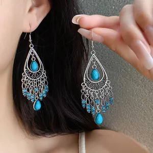 Detailed close-up of Bohemian teardrop tassel earrings featuring elegant blue stones
