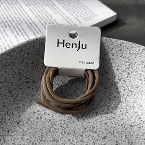 Close-up view of high-stretch brown elastic hair bands on HenJu minimalist product card