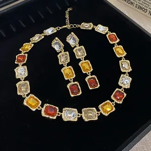 Detail view of colorful square faceted crystal necklace and matching drop earrings set