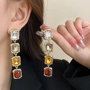 Long geometric square gemstone dangling earrings with multicolor crystals in gold finish.