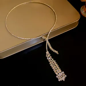 Macro view of a sparkling zircon tassel necklace with intricate gold rhinestone details