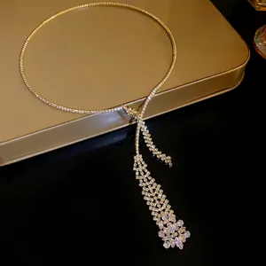 Macro view of a sparkling zirconia tassel necklace with intricate rhinestone details.