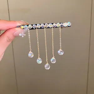 Elegant crystal tassel hair clip featuring sparkling beads and gold-tone chain tassels