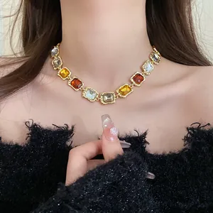 Close-up detail of a vintage multi-color square rhinestone collar necklace worn by model