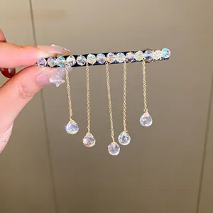 Elegant gold tassel hair clip featuring sparkling crystal beads and hanging droplets.