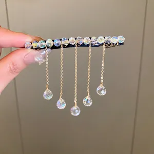 Close-up of elegant crystal fringe hair clip with dangling teardrop pendants