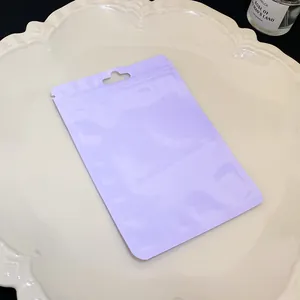 Macro detail of light purple resealable macaron pouch for jewelry on decorative cream plate