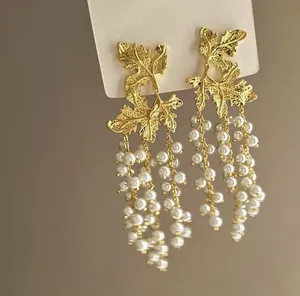 Vintage gold leaf drop earrings featuring elegant long white pearl tassels for women's fashion