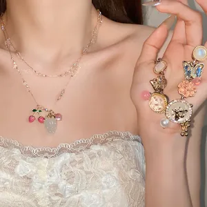 Detail view of crystal rhinestone pendant necklace with strawberry and cherry charms