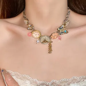 Detailed view of an ornate butterfly and bee charm necklace displayed on a model's neck