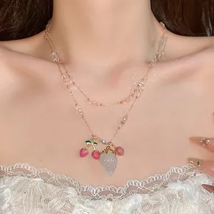 Exquisite double-layer necklace featuring sparkling strawberry and cherry pendants on a model