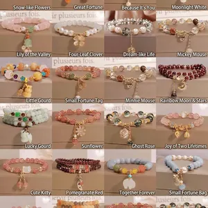 Collection of handmade beaded bracelets with strawberry crystals and diverse charms