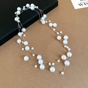 Detailed close-up of a long multi-layered pearl necklace with vintage French style