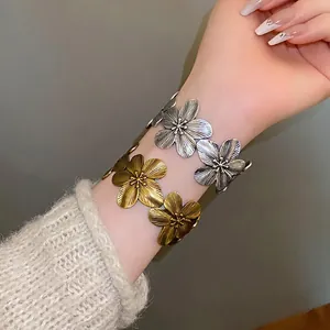 Vintage flower cuff bangles with detailed metallic texture in silver and bronze tones