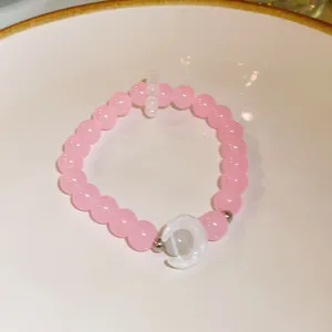 Detailed view of handmade pink crystal bead bracelet with crescent moon charm