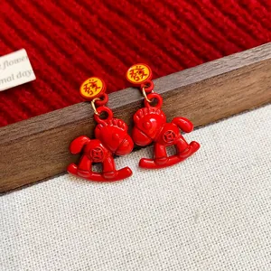 Festive red enamel rocking horse dangle earrings with Chinese character for luck