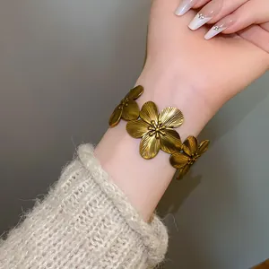 Detailed view of vintage bronze flower bracelet with textured petals worn on wrist
