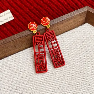 Detailed close-up of festive red New Chinese style earrings with lucky characters