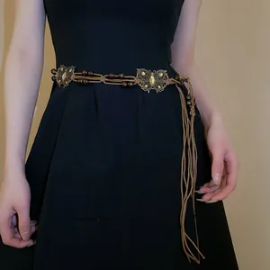 Bohemian ethnic belt with wooden beads and bronze butterfly ornaments on black dress