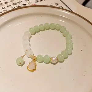 Macro view of handcrafted New Chinese style beaded bracelet with gourd pendant and pearl