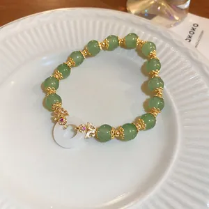 Elegant handmade green stone beaded bracelet featuring a white jade-style ring focal point