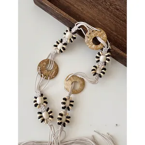 Detail shot of bohemian handmade wooden bead and macrame rope belt with ethnic design