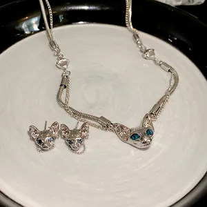 Cyberpunk silver Sphynx cat necklace and earrings jewelry set with blue crystal eyes