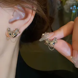 Cyberpunk Sphynx cat head stud earrings with a delicate hanging silver chain detail