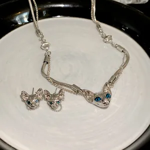 Cyberpunk Sphynx cat head necklace and earrings set with blue eyes in silver metal