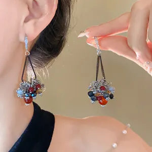 Detailed view of bohemian style earrings featuring colorful glass beads and zircon hooks