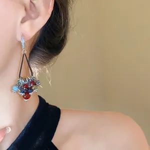 Close-up detail of Bohemian style drop earrings featuring colorful beads and zircons